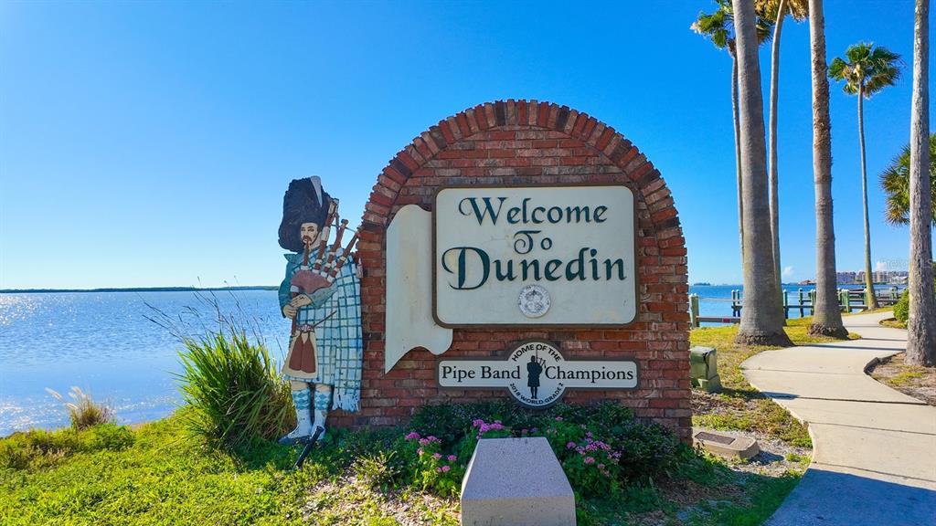 240 President Street Dunedin, FL 34698 - Photo 12 of 19 a view of a sign board with a small yard
