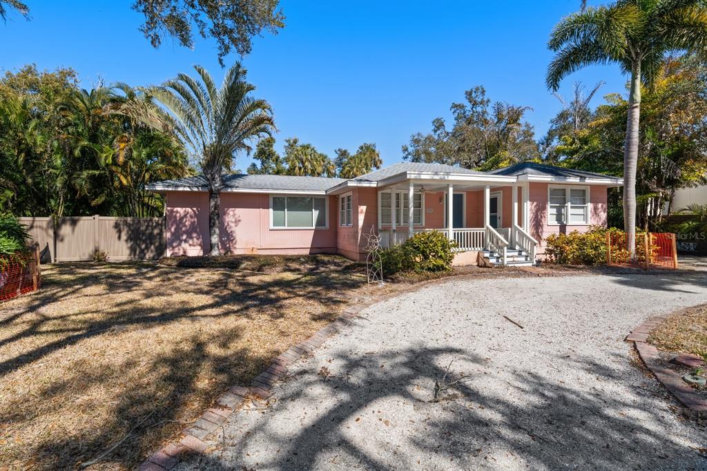 240 President Street Dunedin, FL 34698 - Photo 9 of 19 a front view of a house with garden and trees