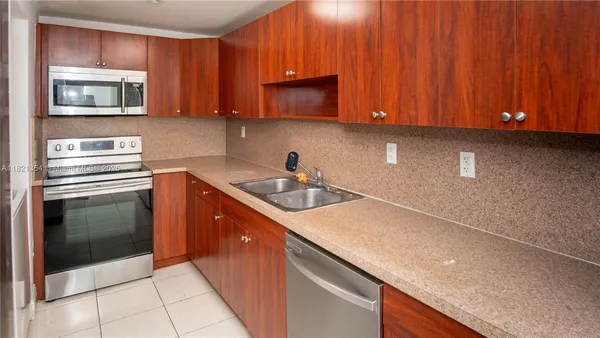 a kitchen with stainless steel appliances granite countertop a sink stove and microwave