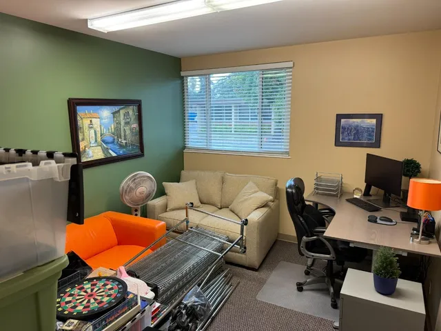 a workspace with furniture and a window