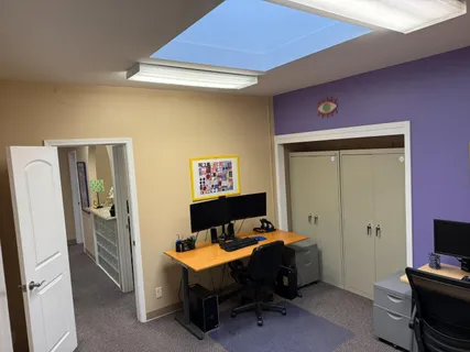 a view of a livingroom with furniture and a workspace