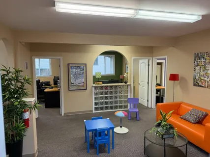a living room with furniture and a potted plant