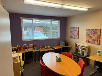 a dining room with furniture a window and wooden floor