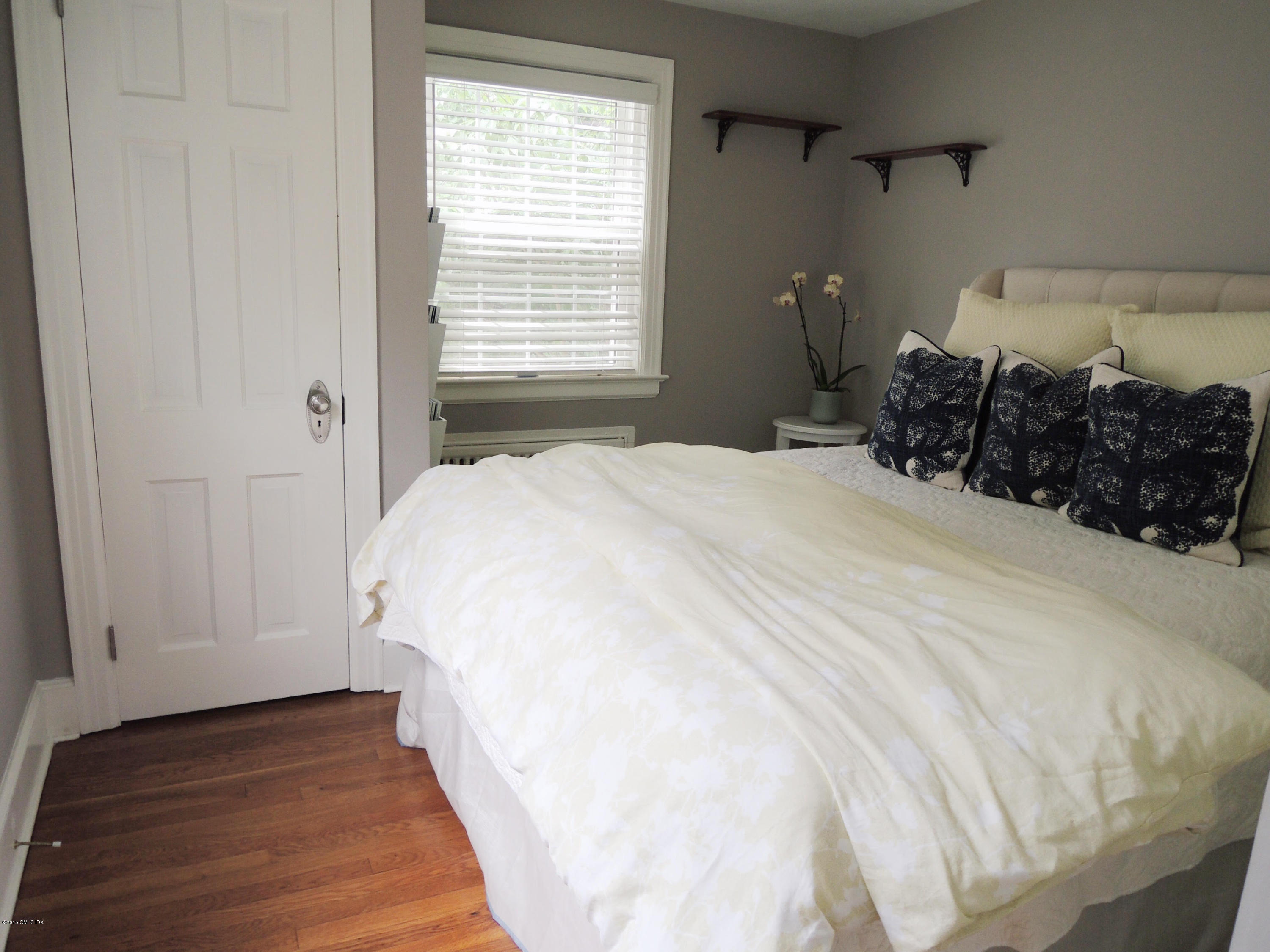 2 Cat Rock Road Cos Cob, CT 06807 - Photo 18 of 42 a bed sitting in a bedroom next to a window