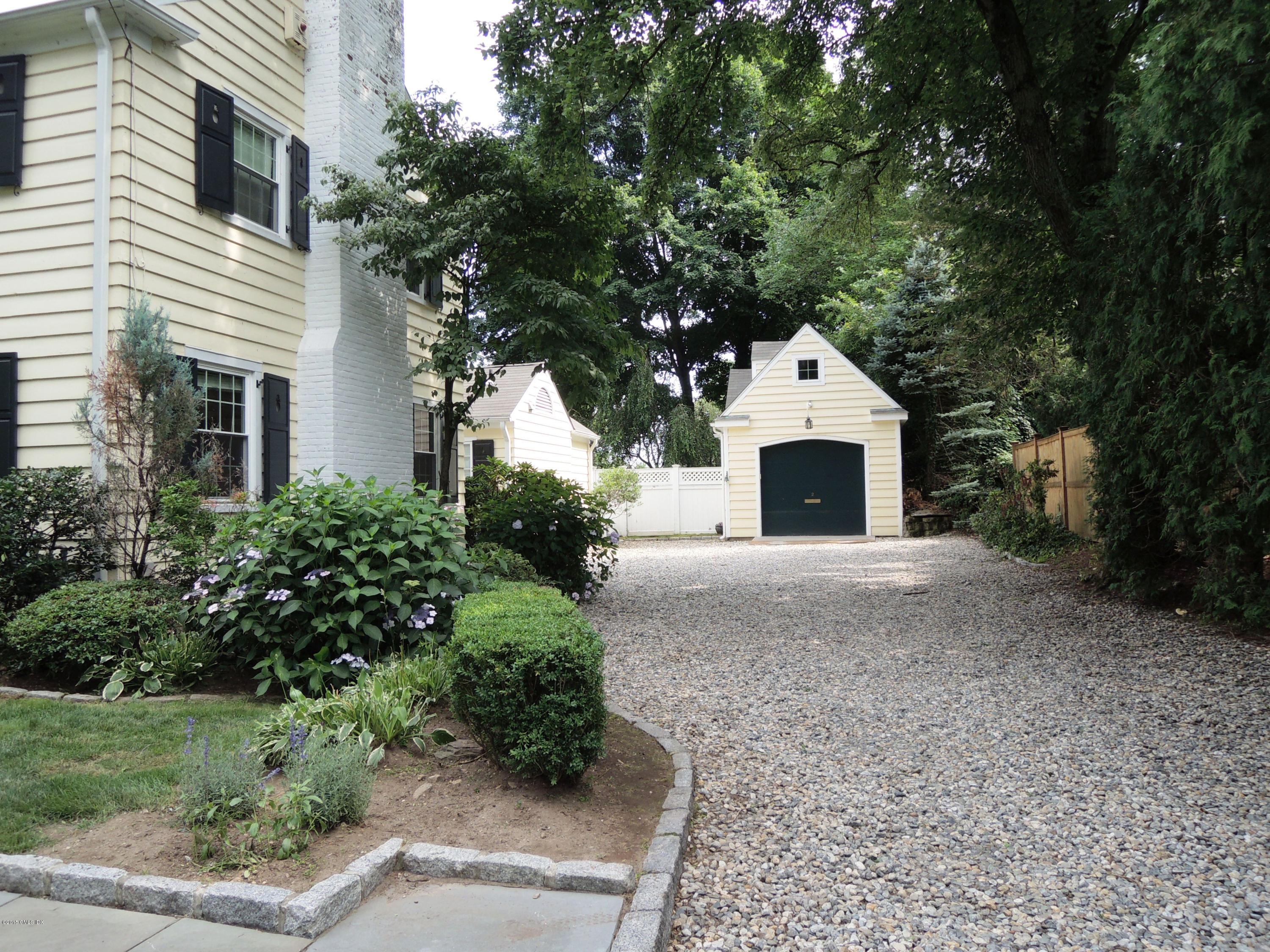 2 Cat Rock Road Cos Cob, CT 06807 - Photo 2 of 42 a front view of a house with a yard and garage