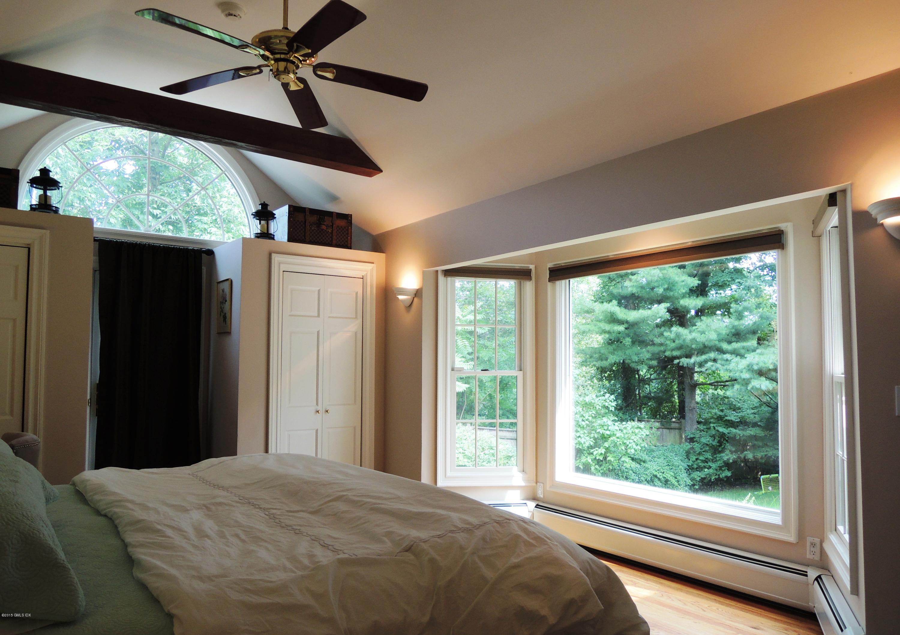 2 Cat Rock Road Cos Cob, CT 06807 - Photo 21 of 42 a bedroom with a bed and a large window