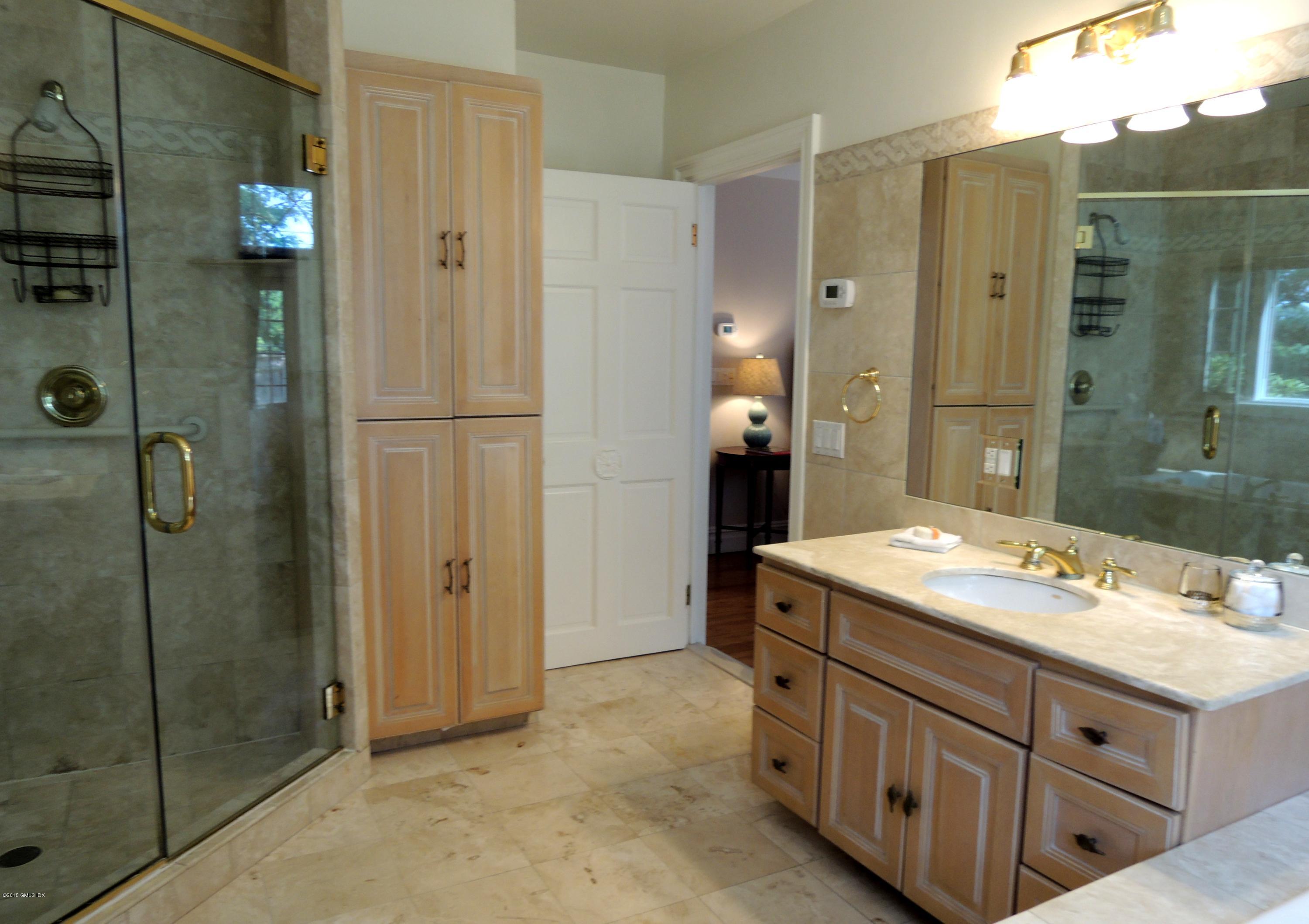 2 Cat Rock Road Cos Cob, CT 06807 - Photo 24 of 42 a bathroom with a granite countertop sink two mirror and shower