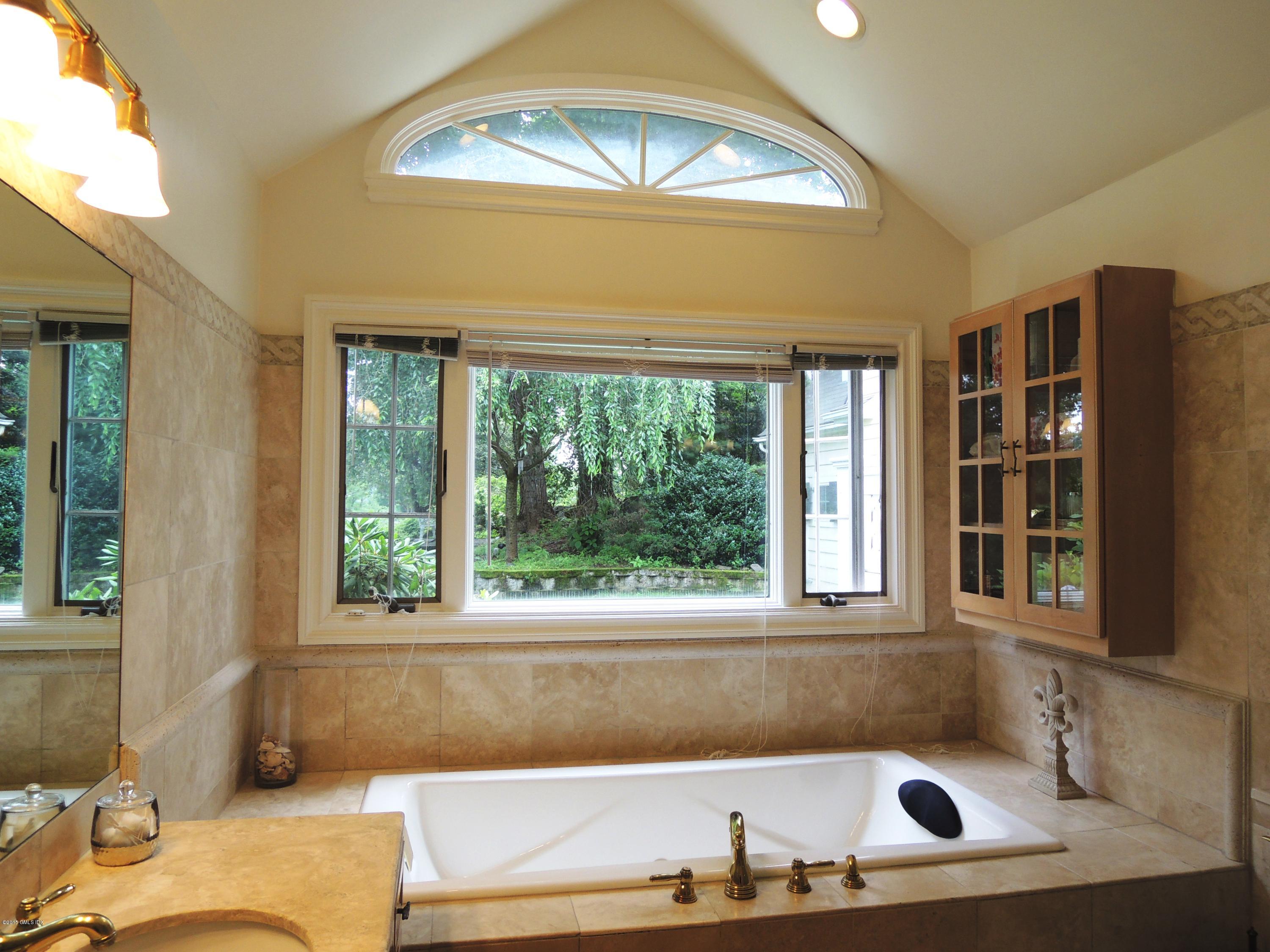 2 Cat Rock Road Cos Cob, CT 06807 - Photo 25 of 42 a bath tub sitting in a bathroom next to a window