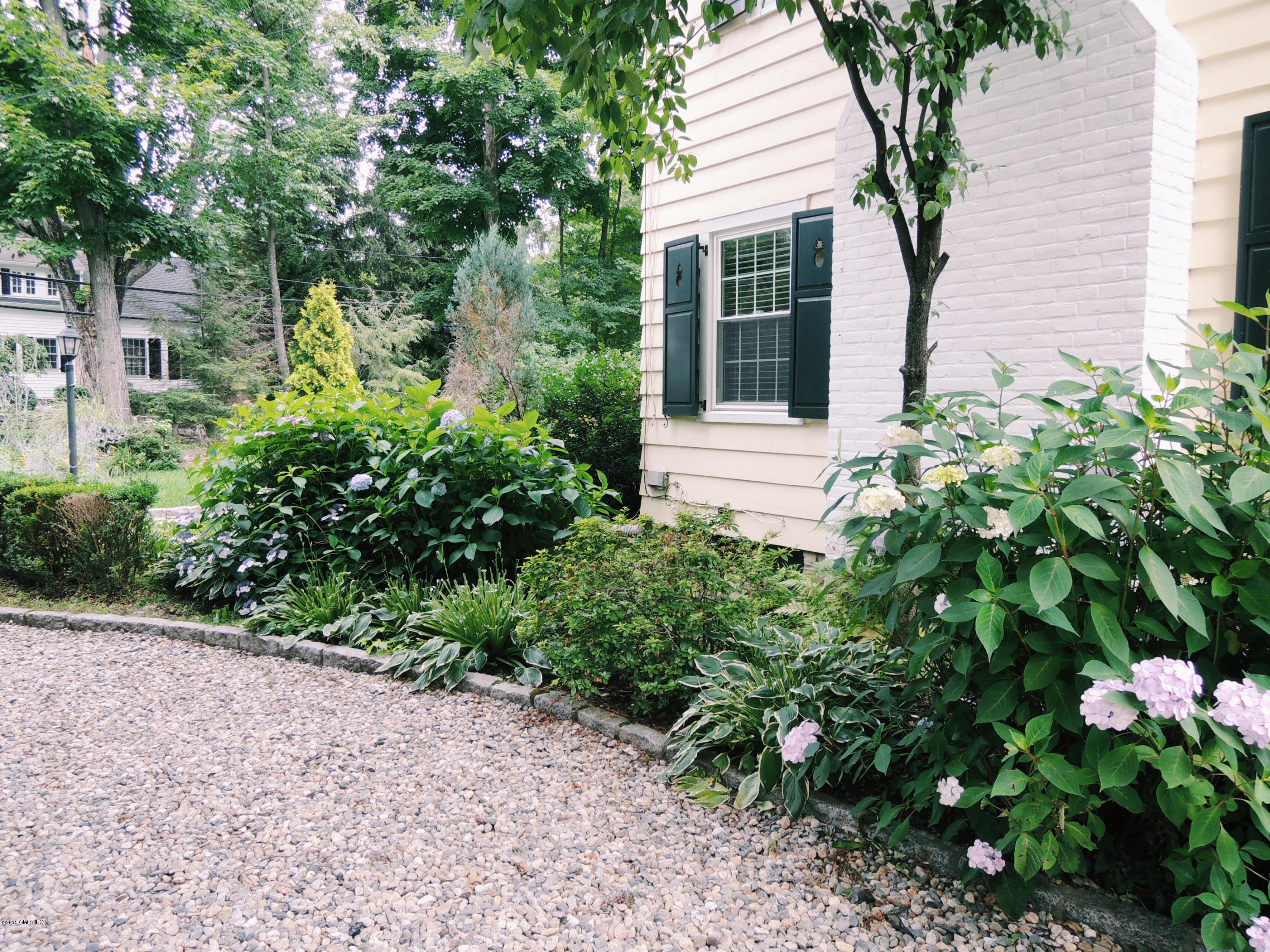 2 Cat Rock Road Cos Cob, CT 06807 - Photo 3 of 42 a view of a house with a yard and plants