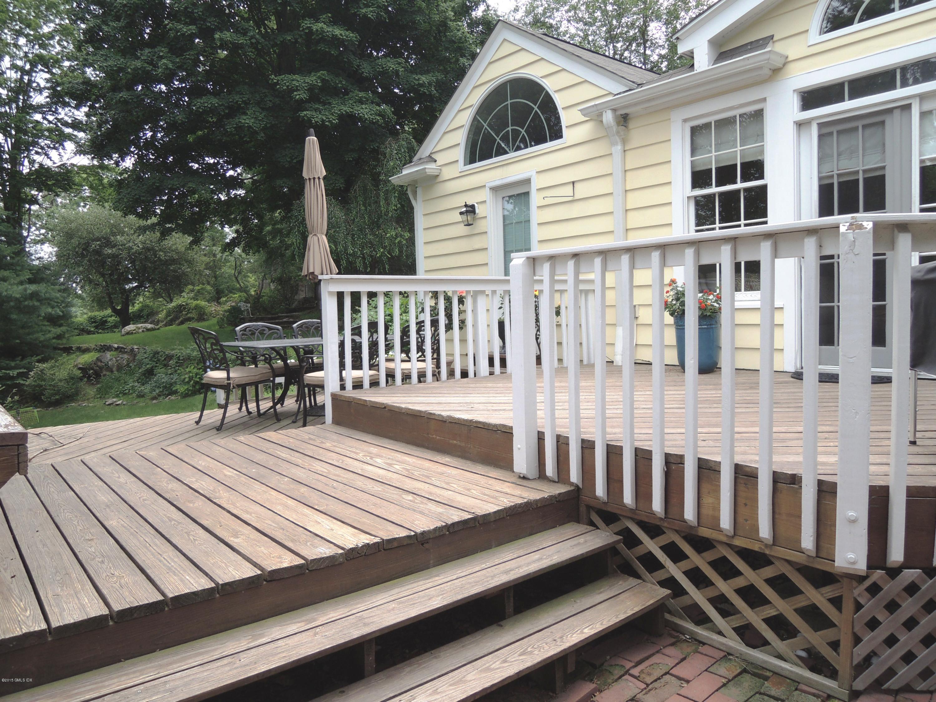 2 Cat Rock Road Cos Cob, CT 06807 - Photo 32 of 42 a view of a wooden chairs and a bench in the patio