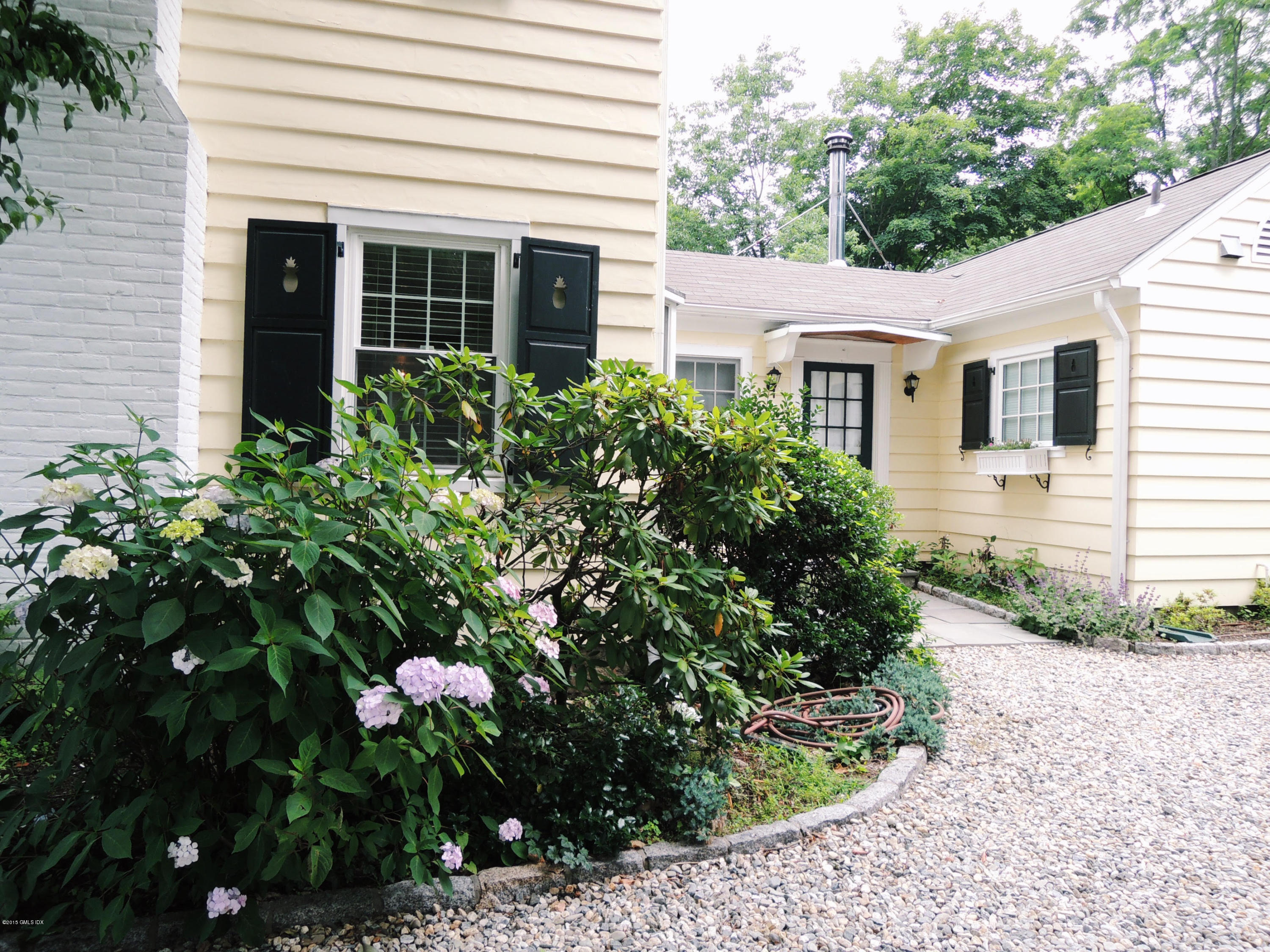 2 Cat Rock Road Cos Cob, CT 06807 - Photo 4 of 42 a front view of a house with a yard