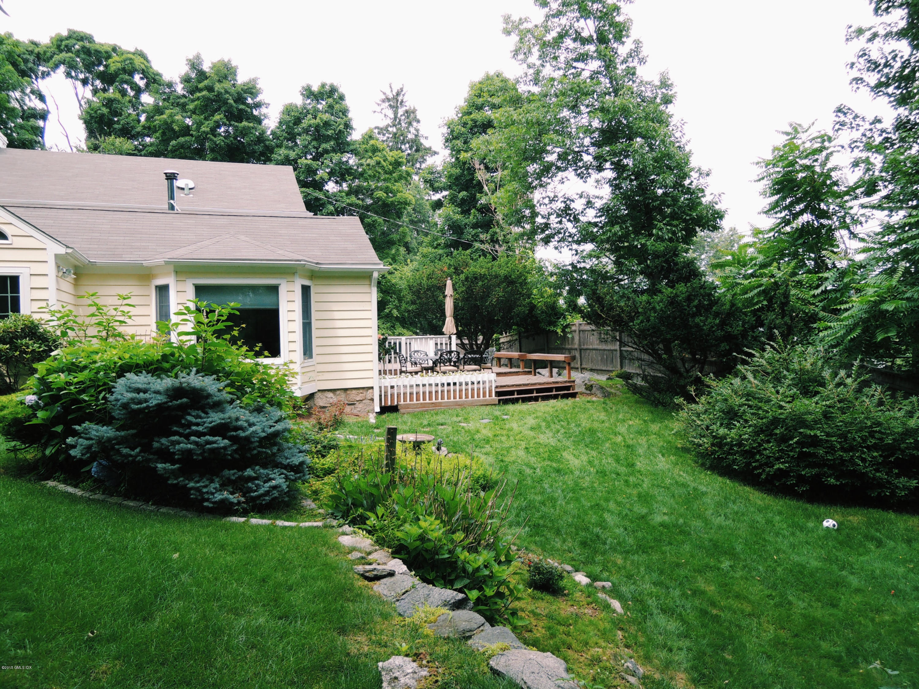 2 Cat Rock Road Cos Cob, CT 06807 - Photo 42 of 42 a backyard of a house with table and chairs plants and large tree