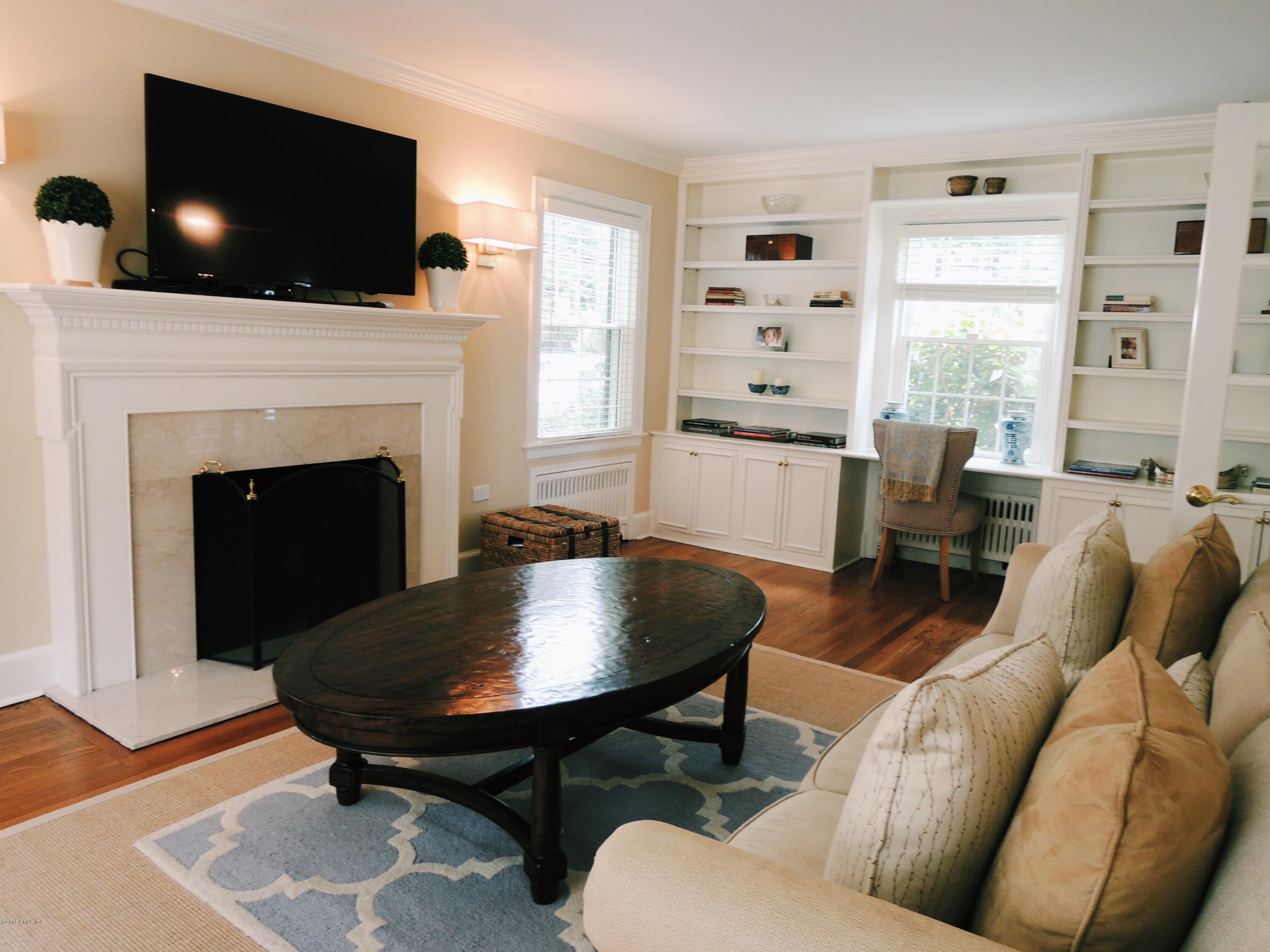 2 Cat Rock Road Cos Cob, CT 06807 - Photo 7 of 42 a living room with furniture a flat screen tv and a fireplace