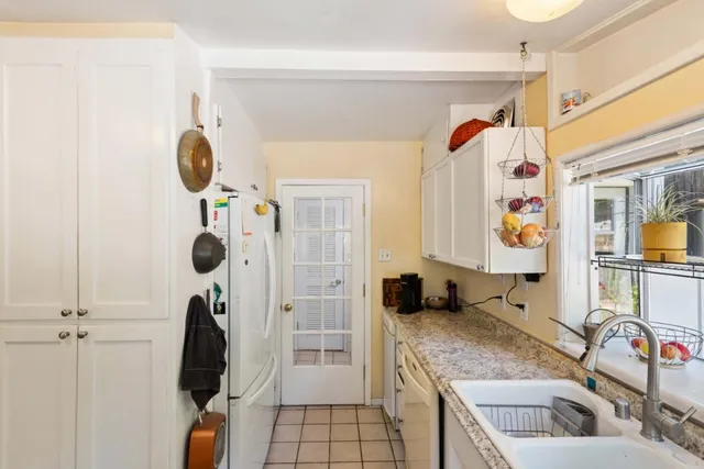 a bathroom with a granite countertop shower a sink and a mirror