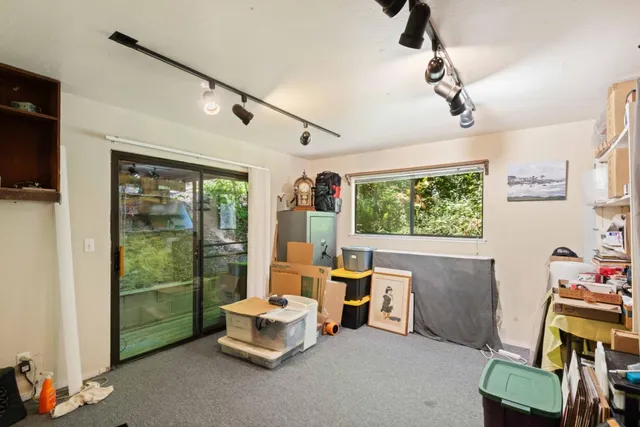 a view of a patio with table and chairs with wooden floor and fence