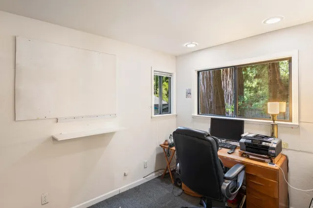 a view of a livingroom with furniture and a window