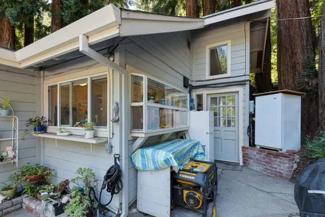a view of a patio with table and chairs potted plants with wooden fence