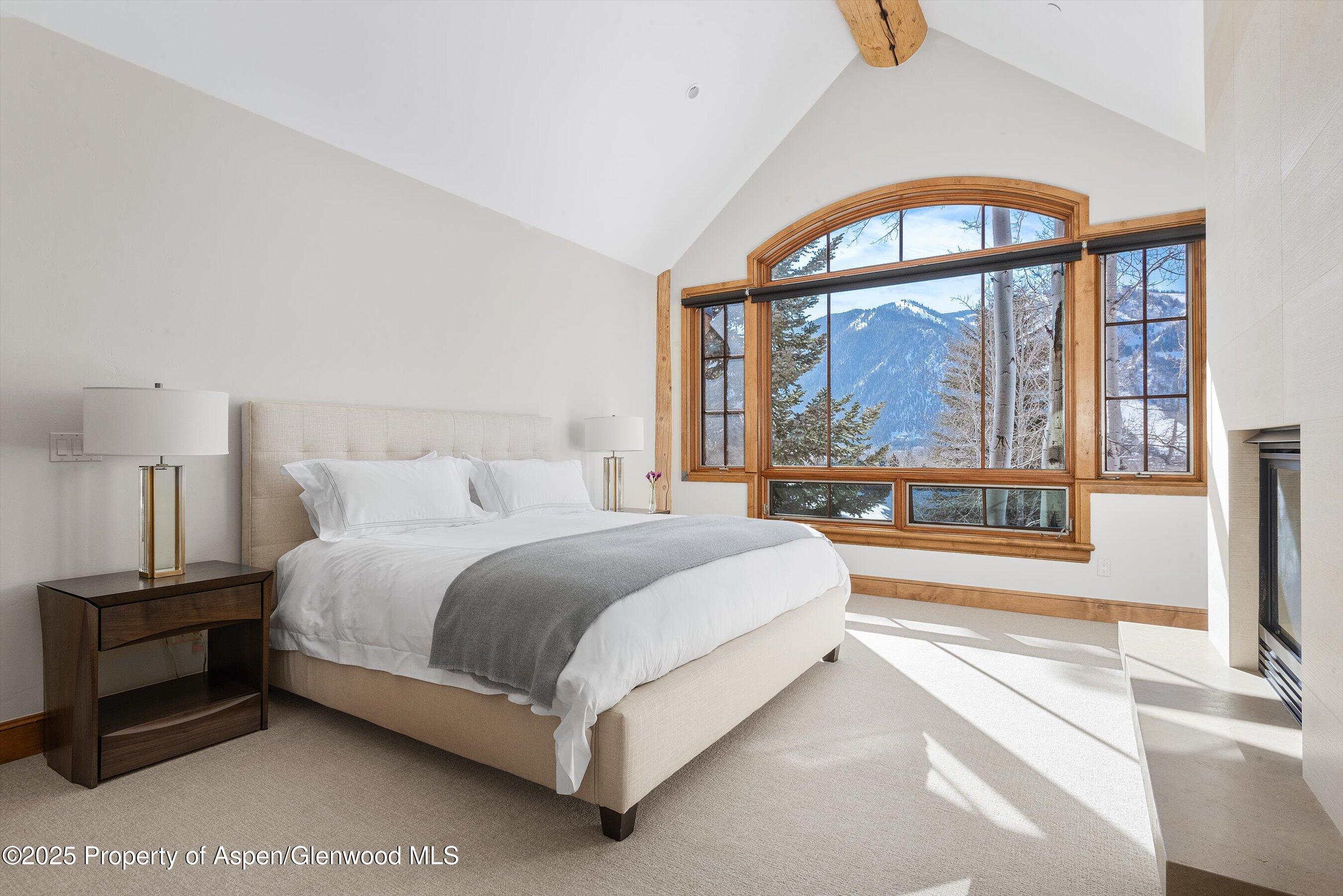 415 Silverlode Drive Aspen, CO 81611 - Photo 11 of 26 a spacious bedroom with a bed and a large window