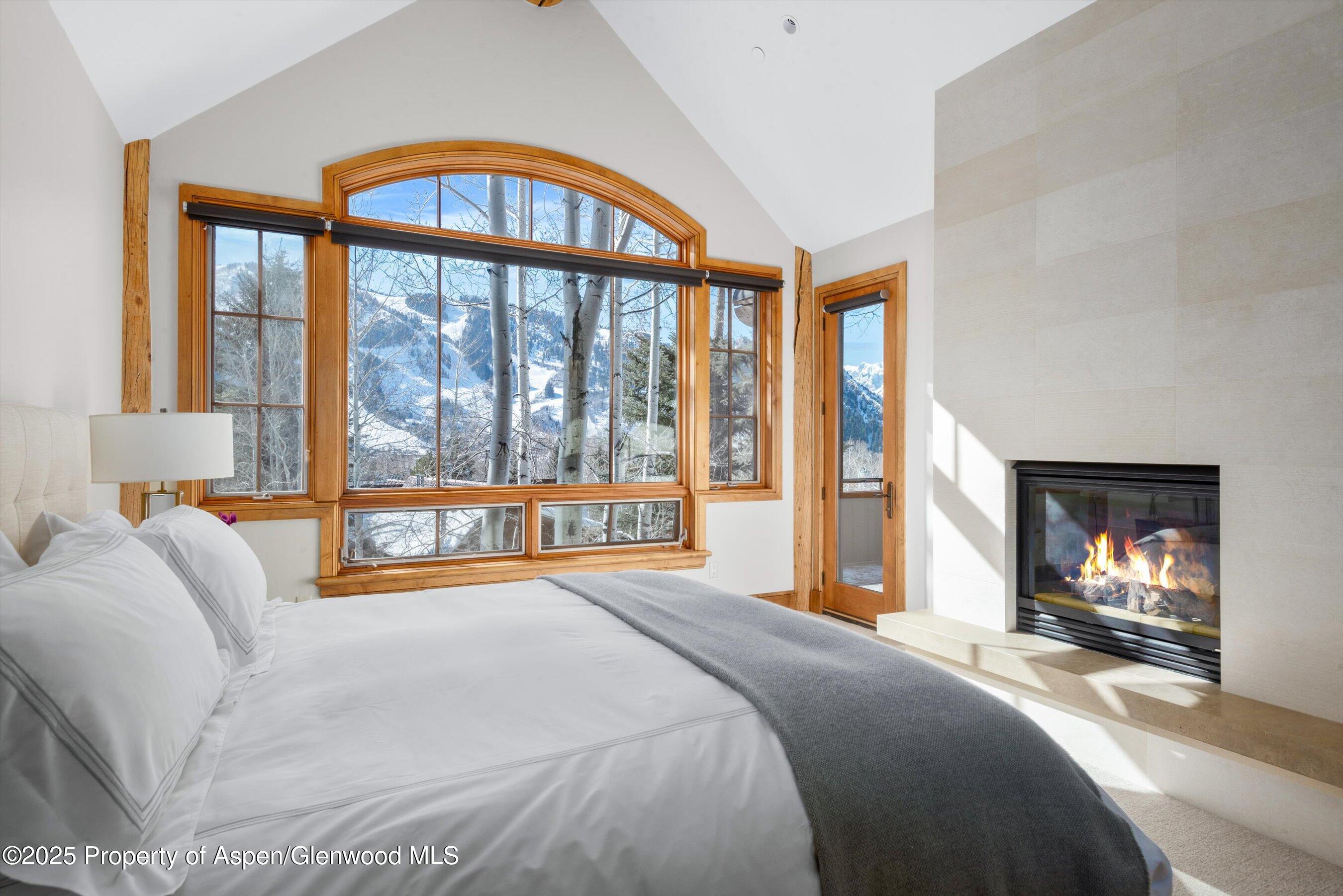 415 Silverlode Drive Aspen, CO 81611 - Photo 12 of 26 a bedroom with a bed and a large window