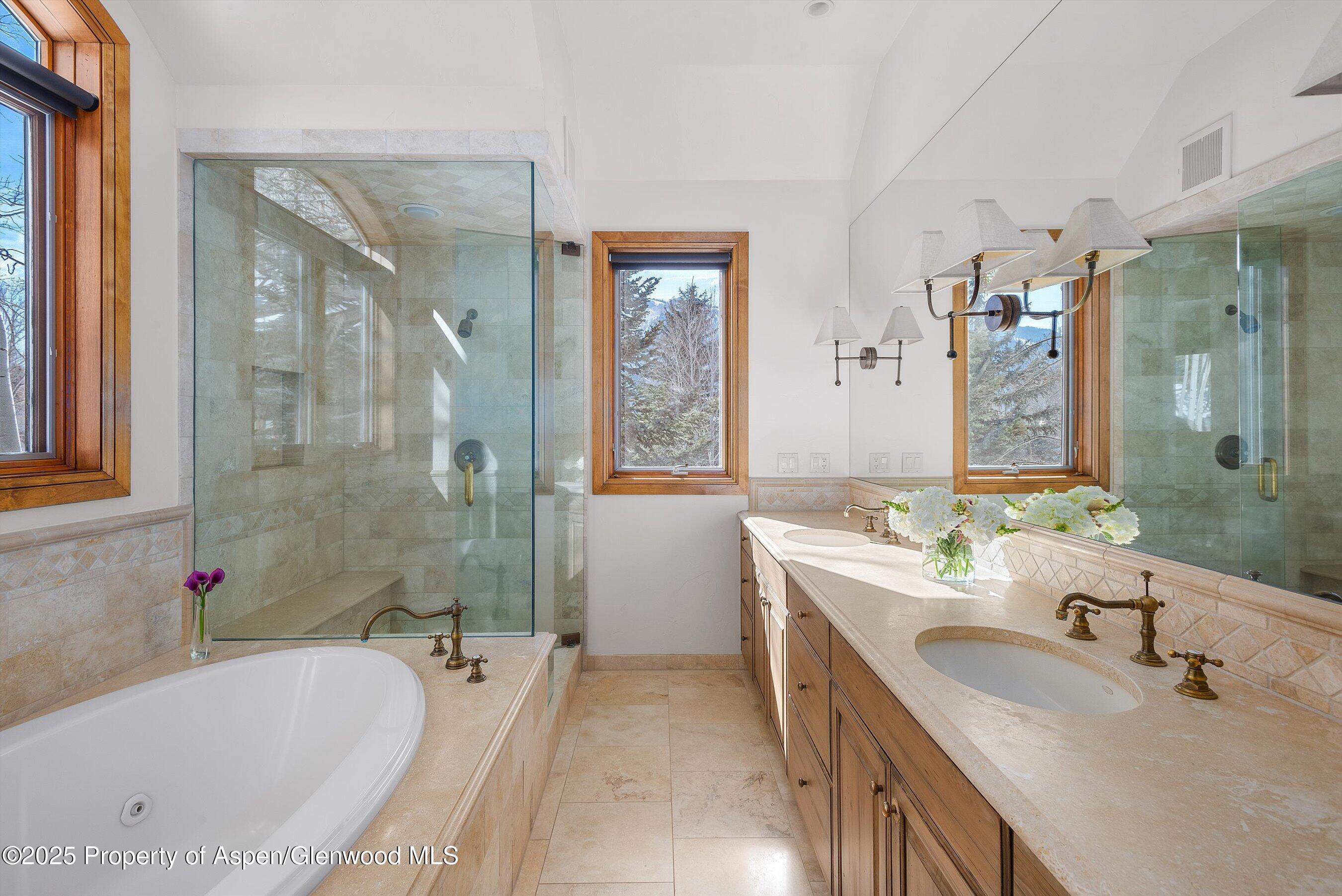 415 Silverlode Drive Aspen, CO 81611 - Photo 15 of 26 a bathroom with a tub a sink double vanity and a mirror
