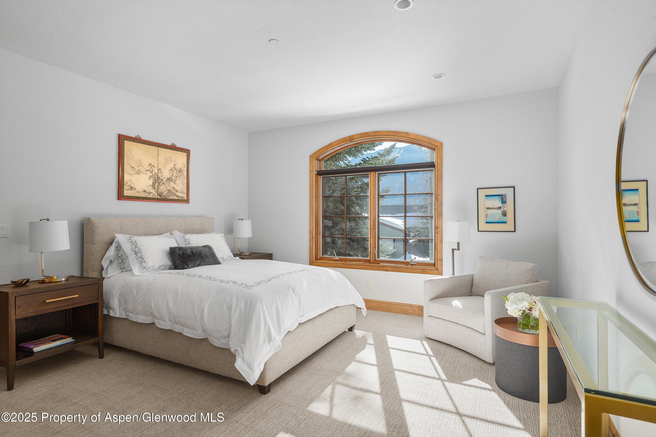 415 Silverlode Drive Aspen, CO 81611 - Photo 17 of 26 a bedroom with a bed and a large window