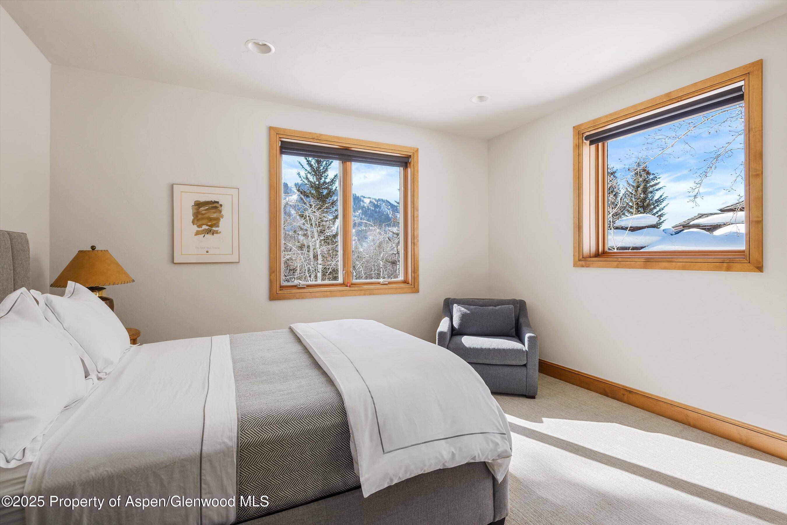 415 Silverlode Drive Aspen, CO 81611 - Photo 19 of 26 a bedroom with a bed and a painting on the wall