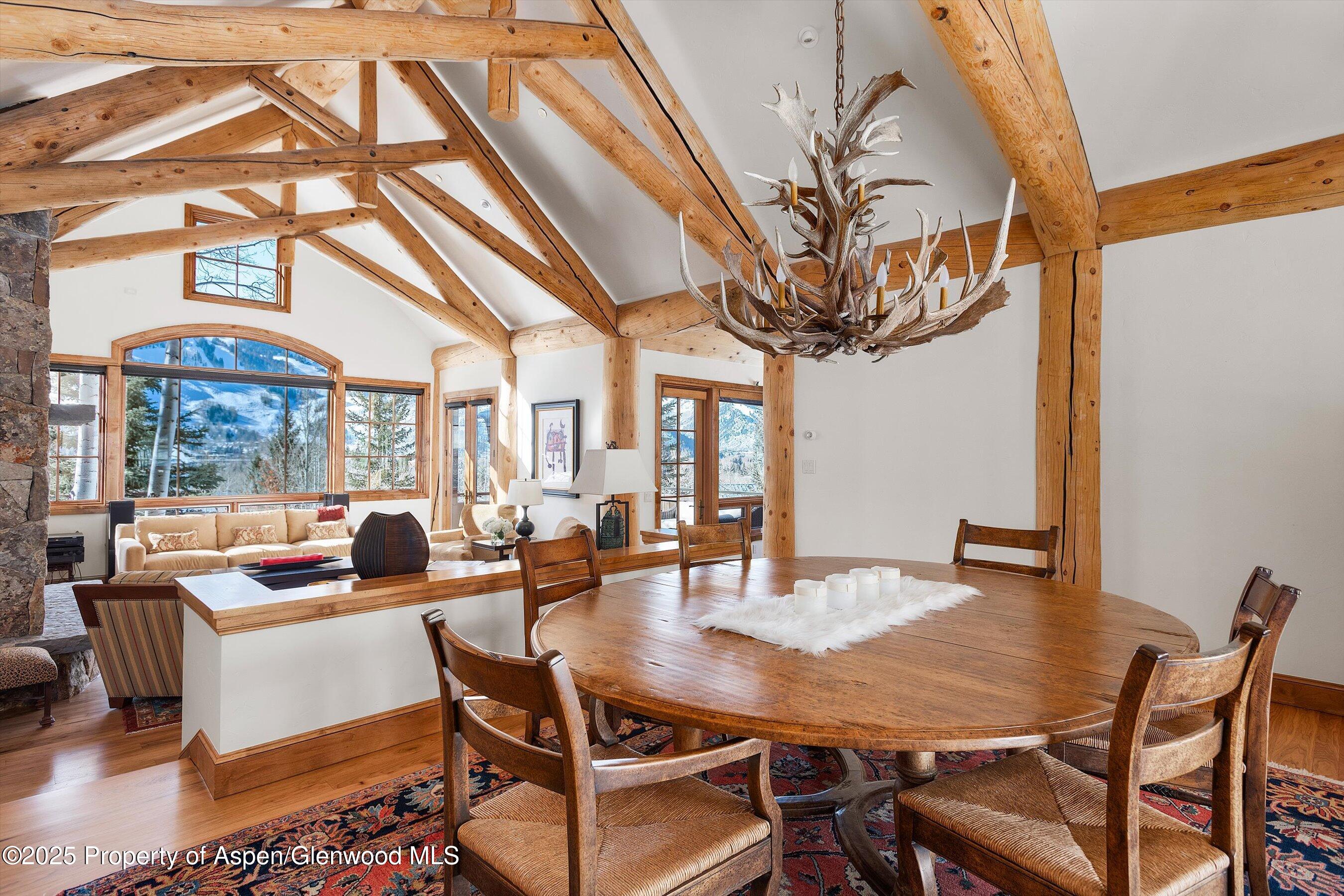 415 Silverlode Drive Aspen, CO 81611 - Photo 3 of 26 a dining room with furniture a chandelier and wooden floor