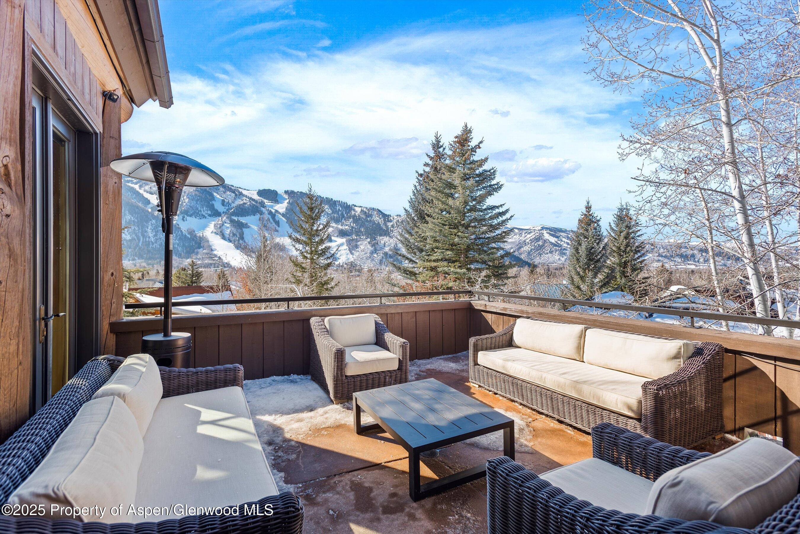415 Silverlode Drive Aspen, CO 81611 - Photo 9 of 26 a view of a patio with couches chairs and a table