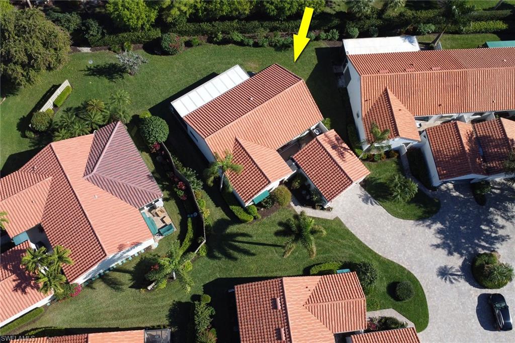 an aerial view of a house with garden space and street view