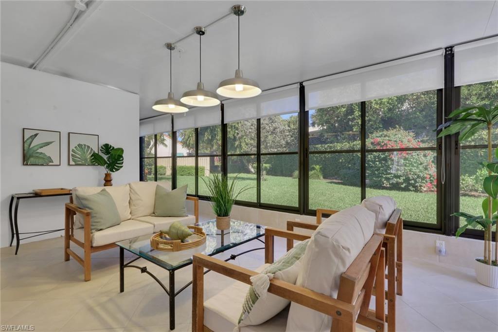 796 Reef Point Circle Naples, FL 34108 - Photo 12 of 37 a living room with furniture and a large window