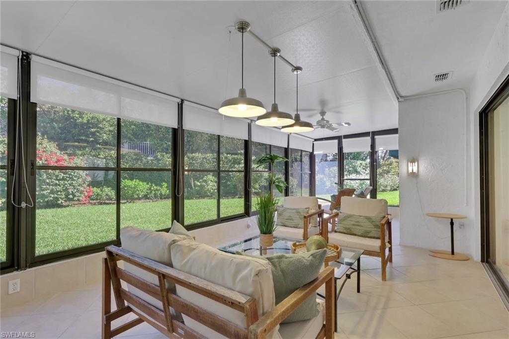 796 Reef Point Circle Naples, FL 34108 - Photo 13 of 37 a living room with furniture and a large window