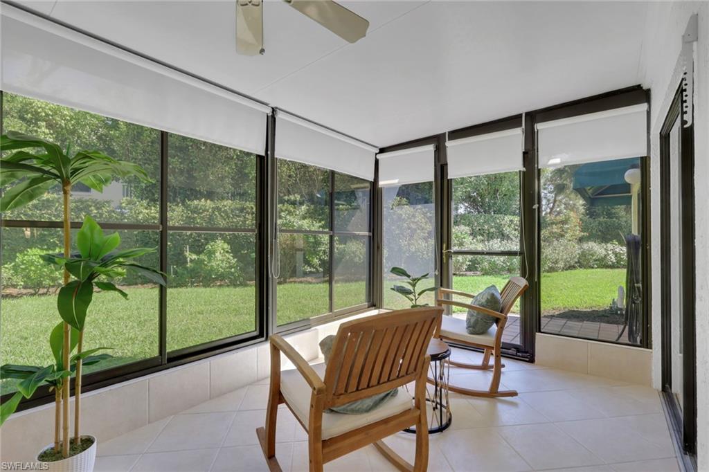 796 Reef Point Circle Naples, FL 34108 - Photo 14 of 37 a bedroom with furniture and large windows