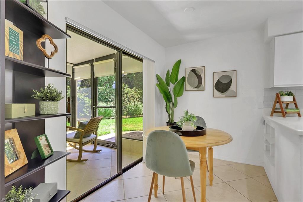 796 Reef Point Circle Naples, FL 34108 - Photo 18 of 37 a living room with furniture and a floor to ceiling window