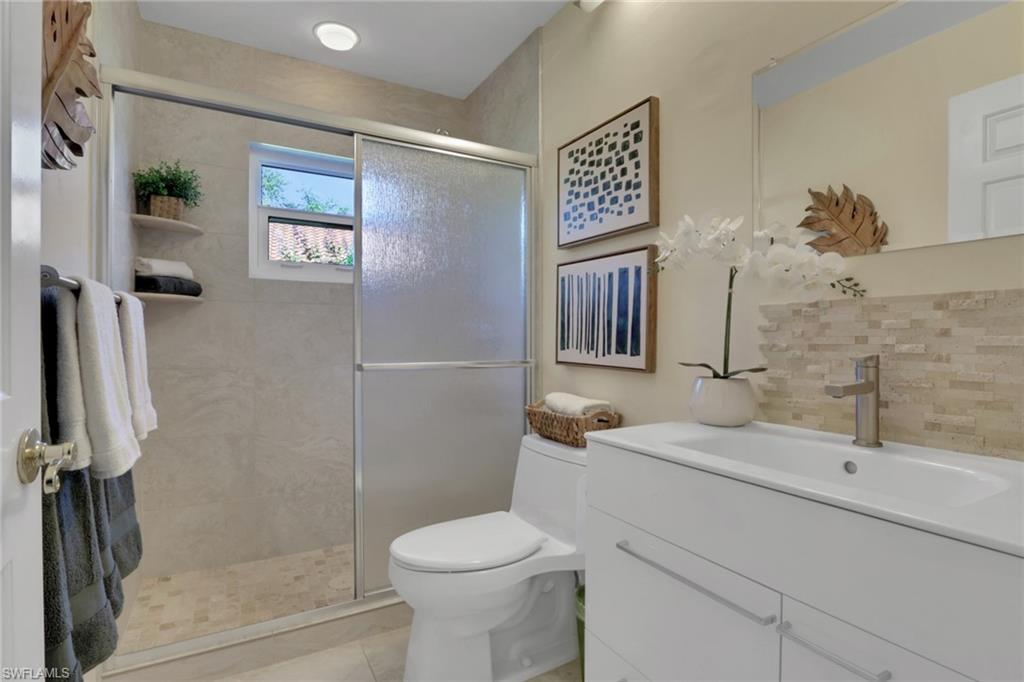 796 Reef Point Circle Naples, FL 34108 - Photo 20 of 37 a bathroom with a sink toilet and shower