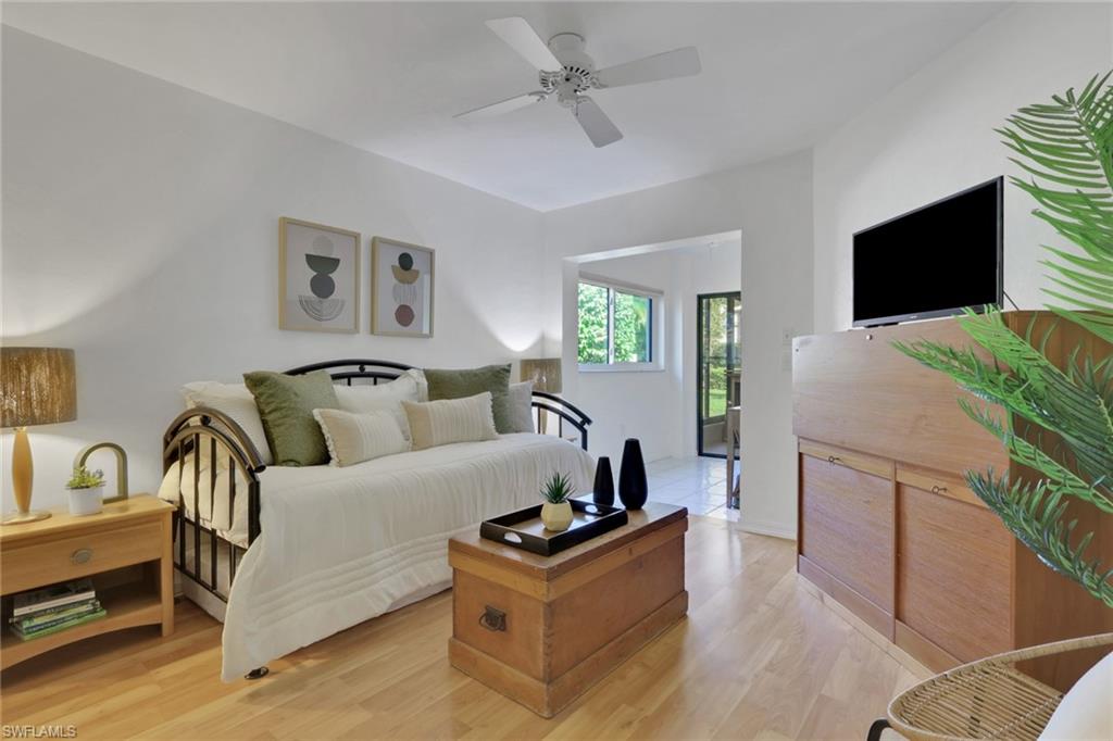 796 Reef Point Circle Naples, FL 34108 - Photo 21 of 37 a living room with furniture and a flat screen tv