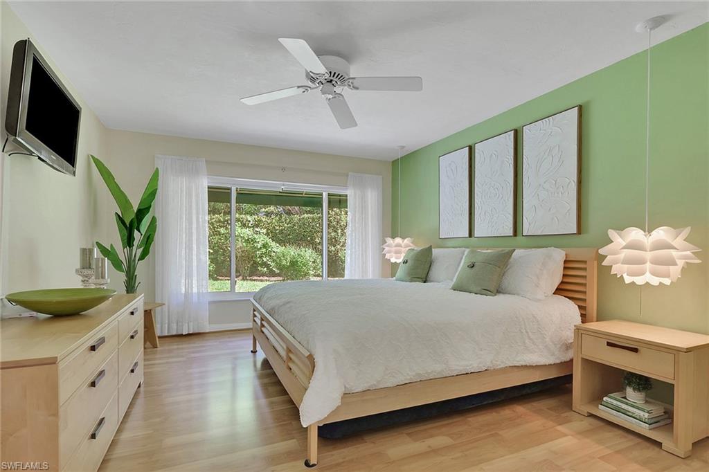 796 Reef Point Circle Naples, FL 34108 - Photo 22 of 37 a bedroom with a bed and a flat screen tv