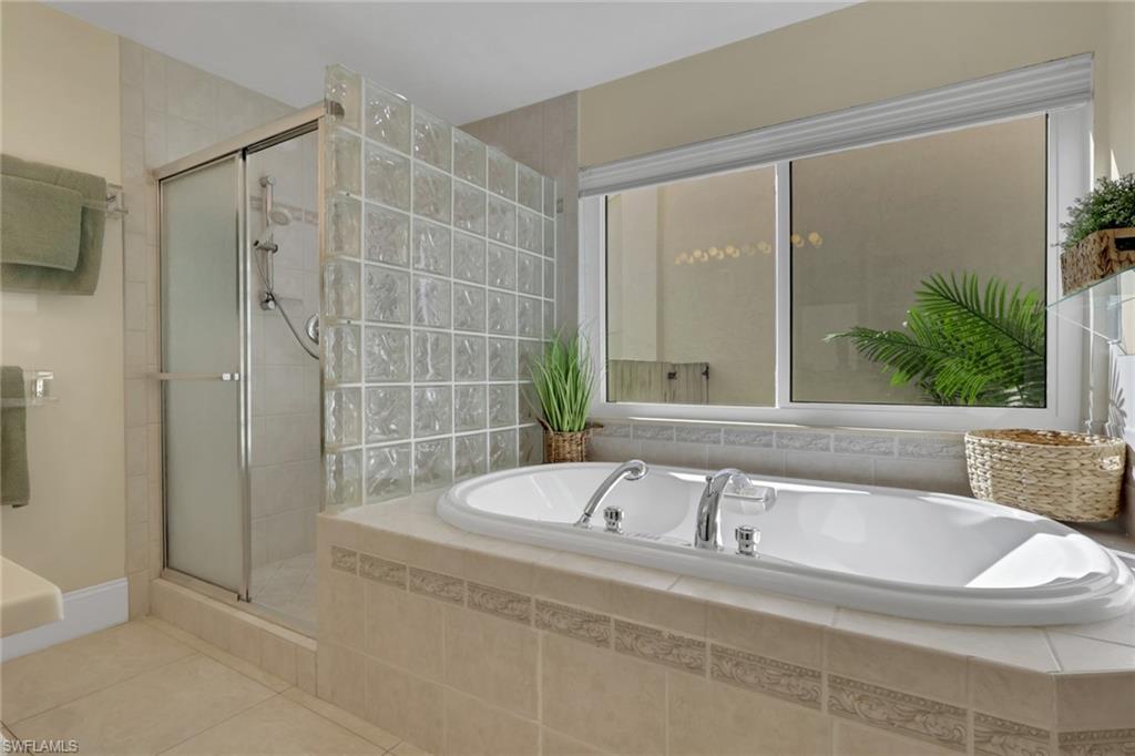796 Reef Point Circle Naples, FL 34108 - Photo 25 of 37 a bathroom with a bathtub and a shower