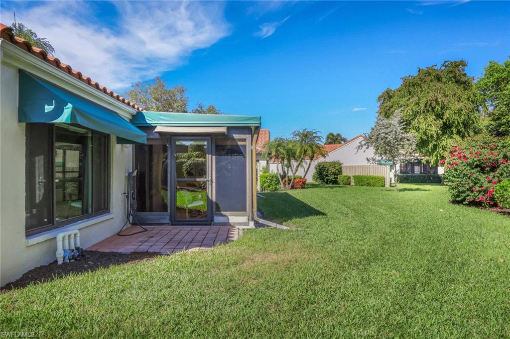 796 Reef Point Circle Naples, FL 34108 - Photo 26 of 37 a view of an house with backyard porch and garden