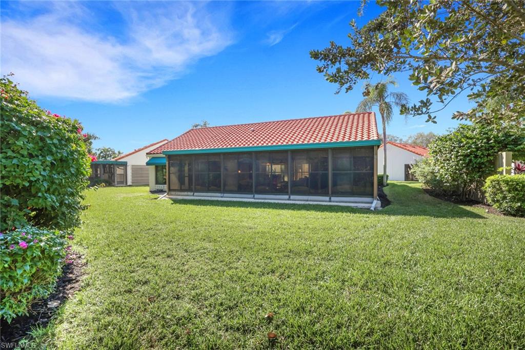 796 Reef Point Circle Naples, FL 34108 - Photo 28 of 37 a front view of a house with a garden
