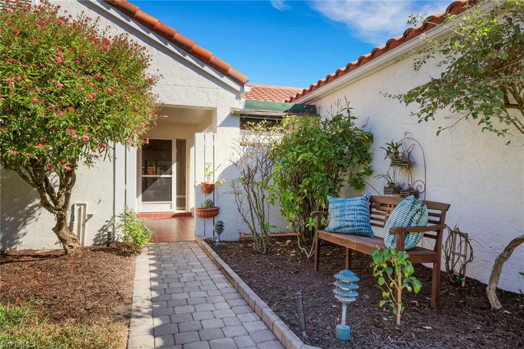 796 Reef Point Circle Naples, FL 34108 - Photo 4 of 37 a view of a patio with table and chairs and potted plants