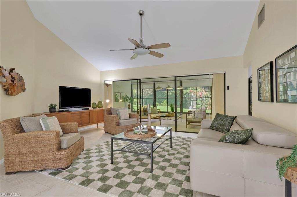 796 Reef Point Circle Naples, FL 34108 - Photo 8 of 37 a living room with furniture and a flat screen tv