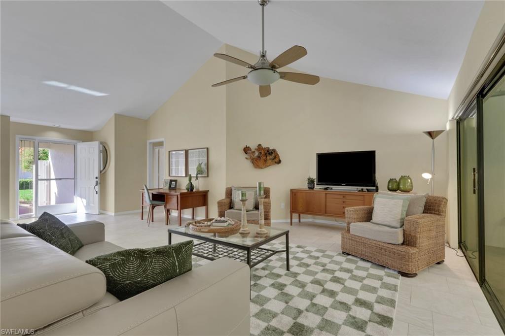 796 Reef Point Circle Naples, FL 34108 - Photo 10 of 37 a living room with furniture and a flat screen tv