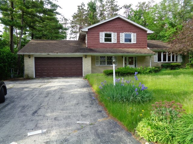 4965 Brigadoon Road Rockford, IL 61107 - Photo 1 of 13 a front view of a house with garden