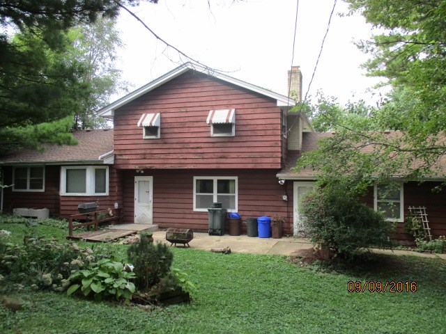 4965 Brigadoon Road Rockford, IL 61107 - Photo 3 of 13 a front view of a house with a garden