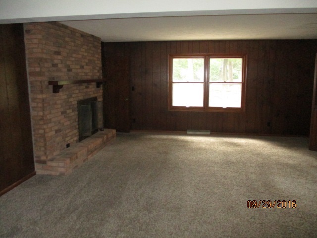 4965 Brigadoon Road Rockford, IL 61107 - Photo 5 of 13 a living room with a fireplace
