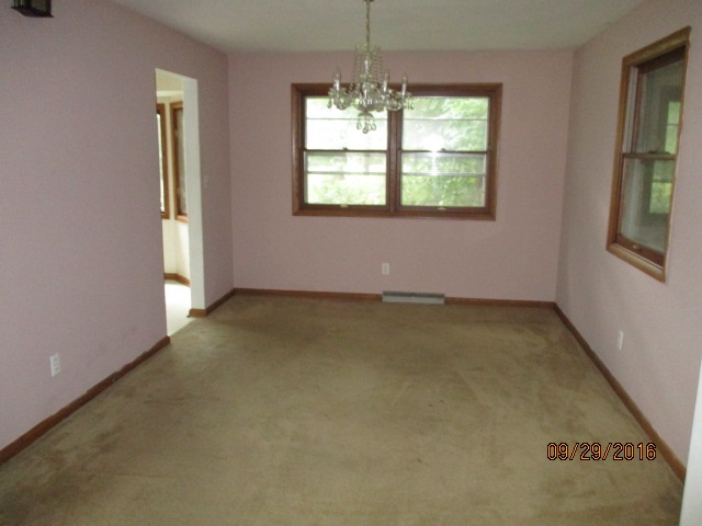 4965 Brigadoon Road Rockford, IL 61107 - Photo 8 of 13 an empty room with windows and chandelier