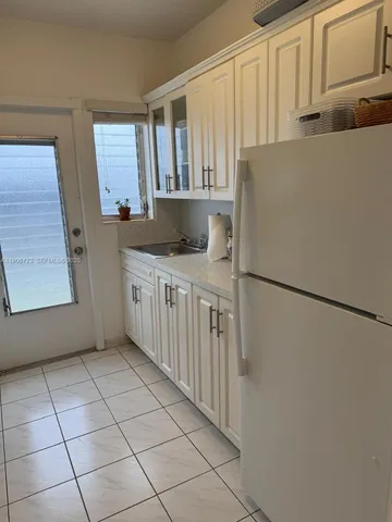 a kitchen with stainless steel appliances a refrigerator and a sink