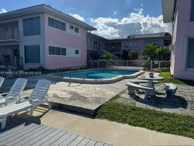 a view of a house with backyard and sitting area