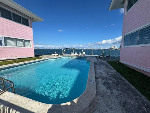 a view of a swimming pool with a yard