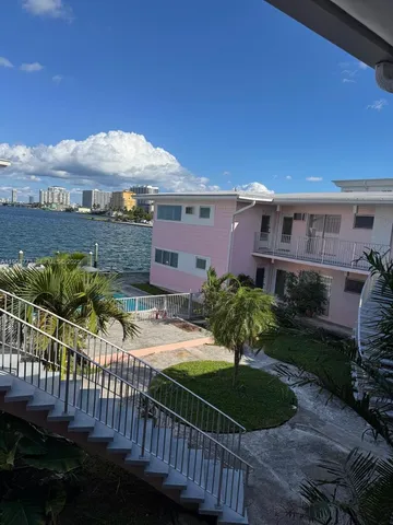 a view of a house with wooden fence